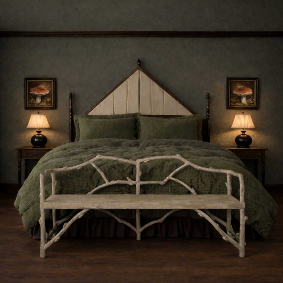 Bedroom with a bed, a bench, and lamps in a moody, dimly lit room. Small mushroom art, black round lamps with pleated shades, and a headboard with a large, triangle top.